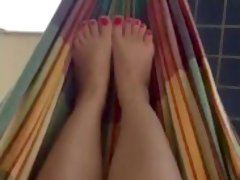 @tici_feet ig tici_feet rubbing my feet in my hammock, red toenails