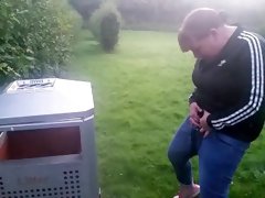 pissing into bin in the park