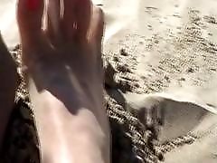 Luxurious young white shemale with nylon feet plays at beach
