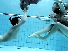 Teens jump in the pool in their cute dresses